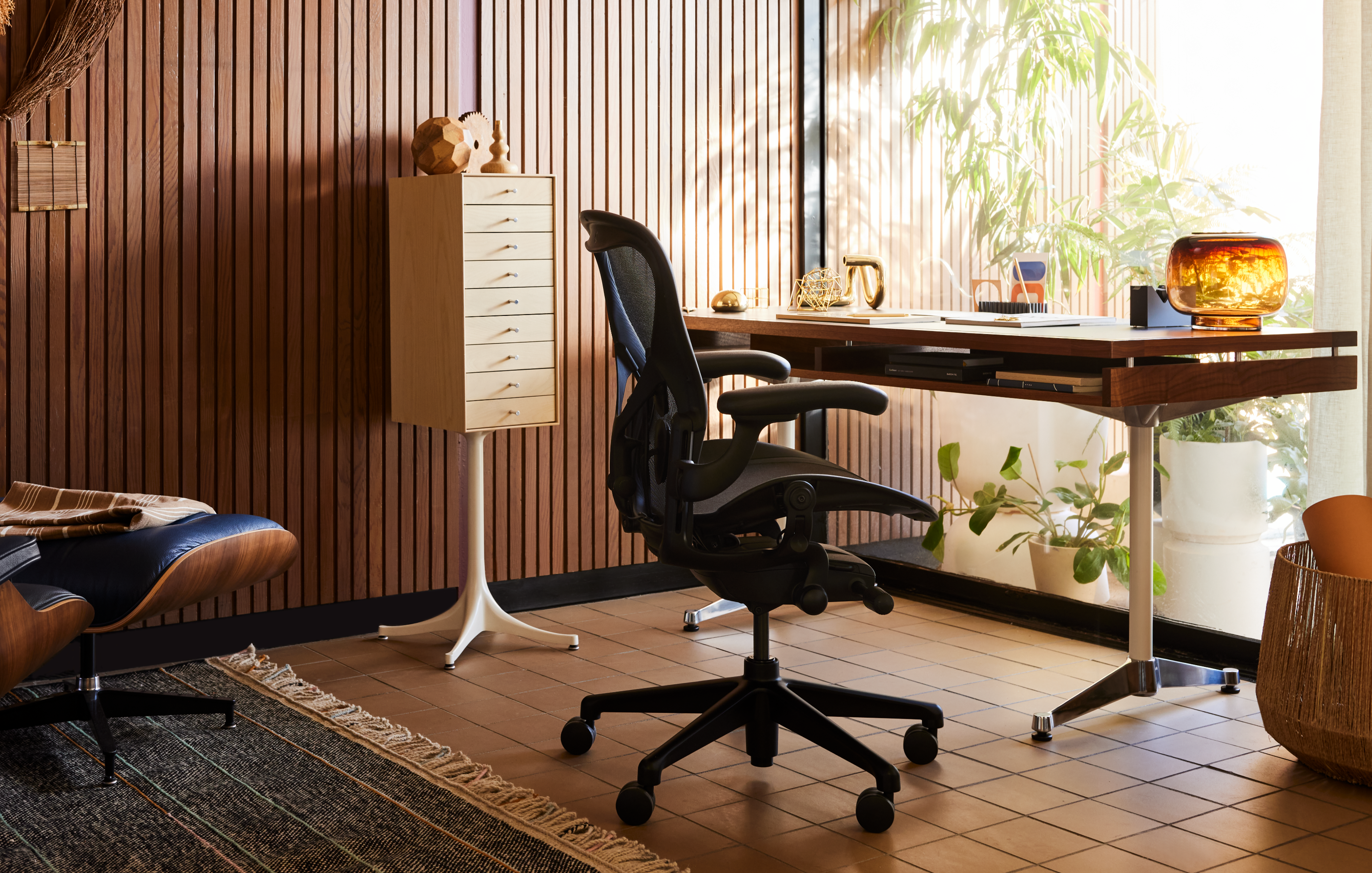 A graphite Aeron with a polished aluminium base in an home office setting