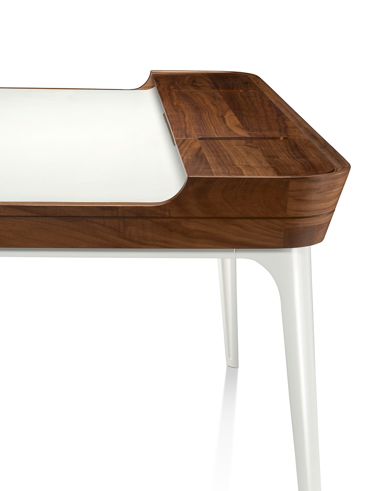 Airia showcases a unique combination of warm and cool materials with its walnut frame and aluminum legs.