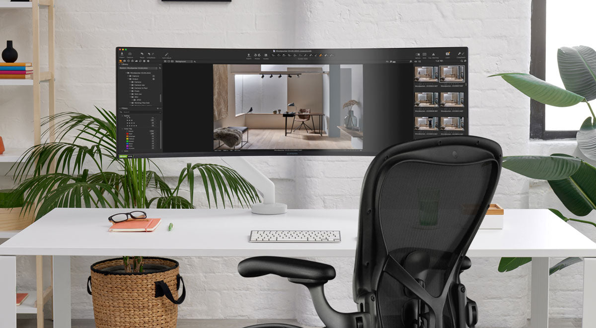 A Flo X monitor arm holding a large-format monitor