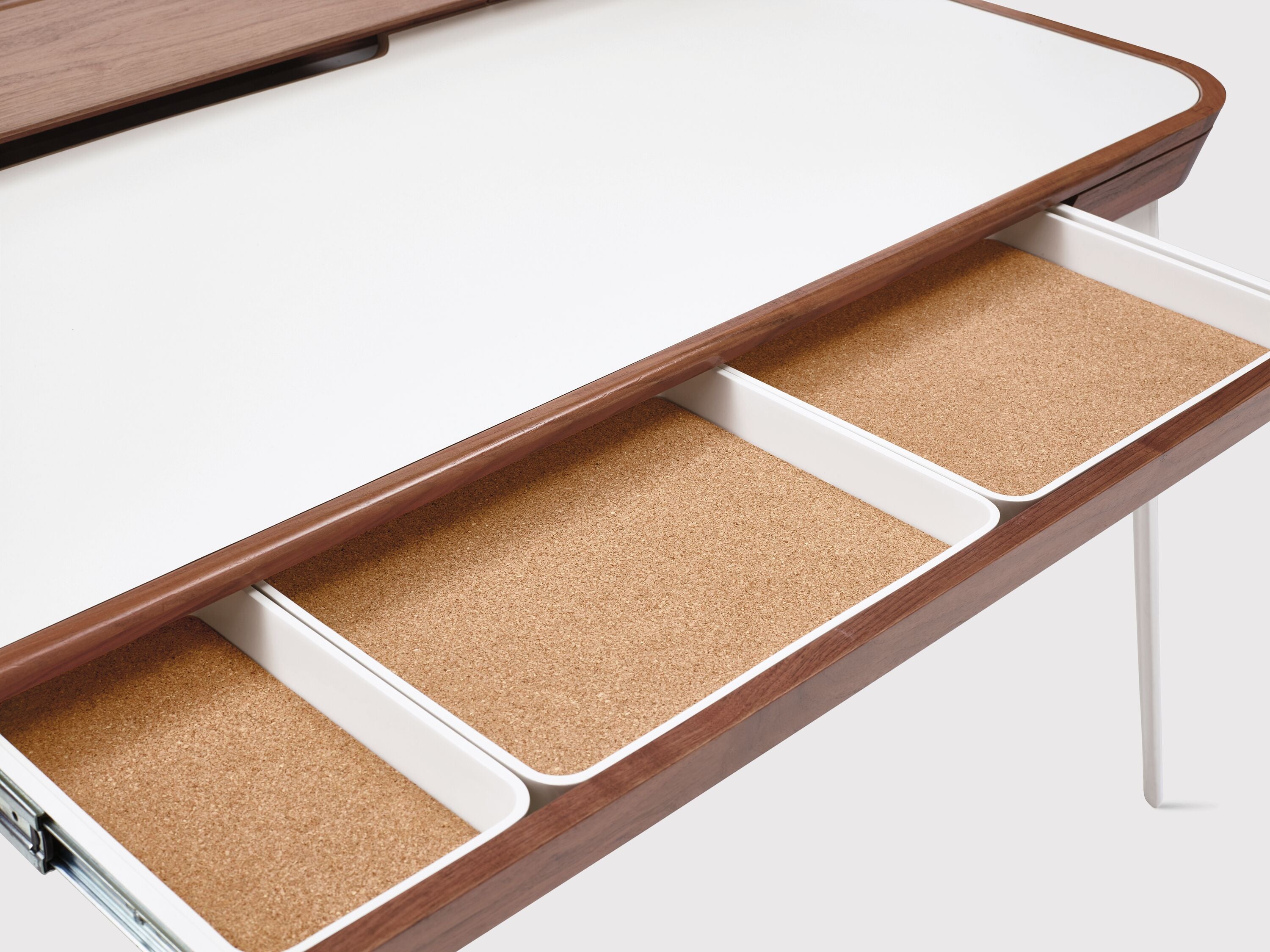Center drawer is outfitted with removable cork-lined organizers.