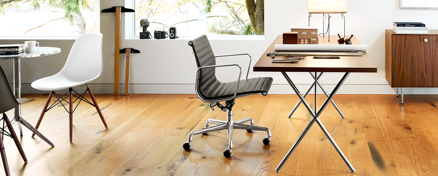 A graphite Aeron with a polished aluminium base in an home office setting