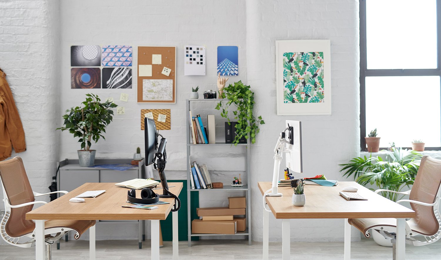 An AbakEnvironments Desk with a walnut top and polished legs, with a graphite Aeron Chair in a light home office setting and Folk Ladder Shelving.