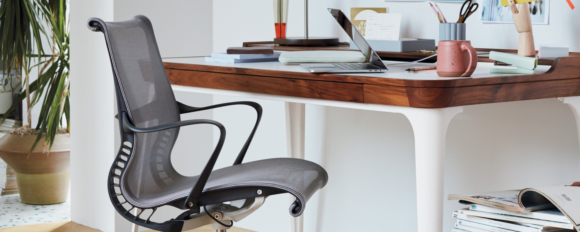 A cut view of a Setu Chair at a home office desk