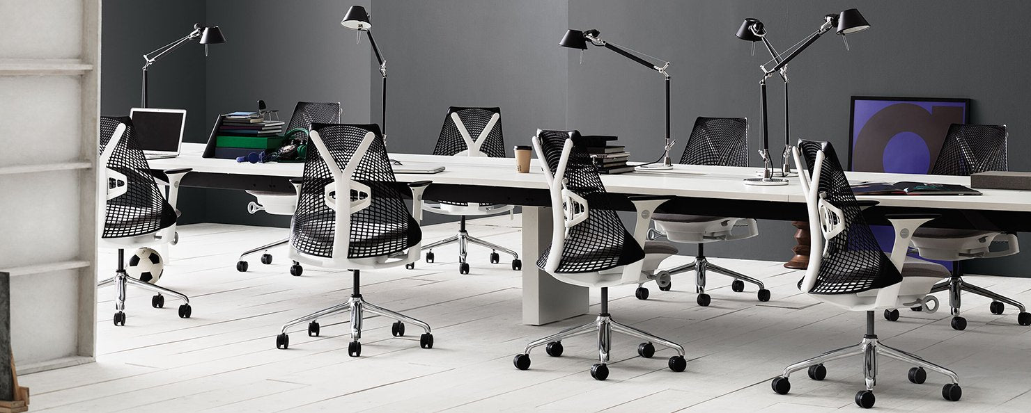 White and black Sayl chairs along a desking bench in an office envrionment