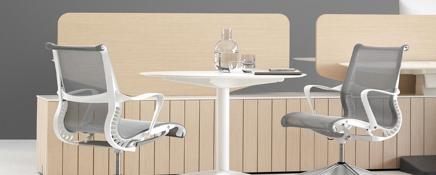 Two grey Setu Stools in a meeting space